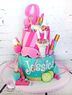 a birthday cake decorated with barbie dolls and accessories