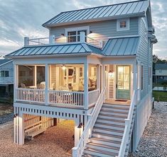 a white house with stairs leading up to it