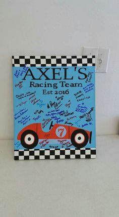 a blue and black sign with autographs on it that says,'axel's racing team est 1950