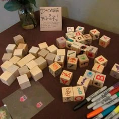 several wooden blocks and markers sitting on a table next to some writing paper with chinese characters