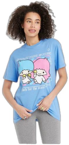 a woman wearing a blue t - shirt with two sheeps on it's chest