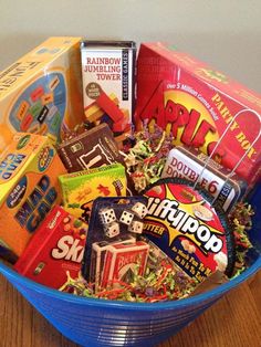 a blue bowl filled with lots of different types of candy