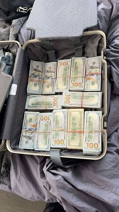 an open suitcase filled with lots of money