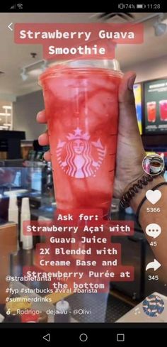 someone holding up a red starbucks cup in front of a computer screen with the text strawberry guava smoothie on it