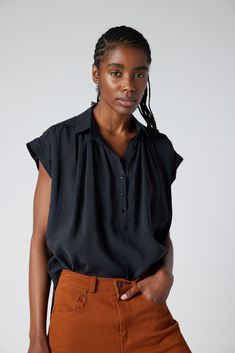 The Nonchalant Oversized Voile Blouse is a graceful fusion of comfort and style that redefines casual elegance. Designed to envelop you in luxurious softness while offering a fashion-forward statement piece that effortlessly complements any occasion. Voile blend fabric Pleated detail on shoulder V-neck Relaxed, oversized fit Classic Black Blouse For Layering, Versatile Rayon Tops For Daywear, Classic Rayon Blouse With Relaxed Fit, Classic Relaxed Fit Rayon Blouse, Classic Blouse With Relaxed Fit, Fall Short Sleeve Viscose Blouse, Chic Relaxed Fit Rayon Blouse, Elegant Relaxed Fit Rayon Tops, Versatile Black Rayon Tops