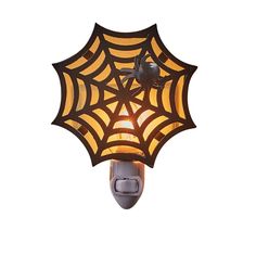 a spider web light fixture on a white wall