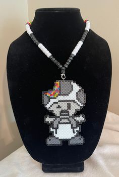 Handmade trippy toad mini perler kandi necklace. Super cute and fun for festivals and other EDM events! Please message with any variations or customizations you might want to make. I'm happy to work with you to make it the perfect piece for you! Thank you for shopping at Byte Size Kandi! Handmade Novelty Adjustable Necklace, Handmade Adjustable Novelty Necklace, Handmade Adjustable Themed Necklace, Themed Handmade Multicolor Necklace, Handmade White Novelty Necklace, White Adjustable Rave Jewelry, Novelty White Handmade Necklace, White Rave Jewelry For Gift, Handmade Multicolor Rave Necklaces