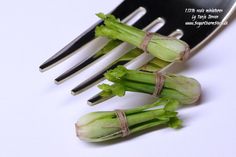 three pieces of asparagus tied to a fork