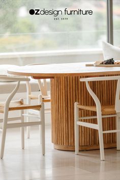 a wooden table with white chairs around it