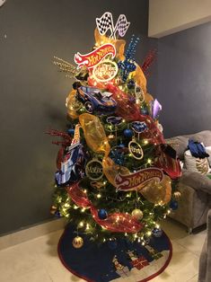 a decorated christmas tree in the corner of a living room with balloons and candy on it