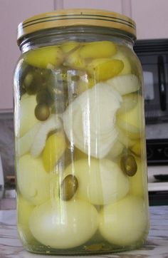 a jar filled with pickled onions on top of a counter