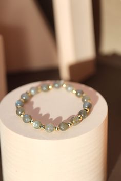 ☾ Dive into the enchanting depths of the cosmos with our Handcrafted Labradorite Bracelet, adorned with luxurious gold accents. Each bead, meticulously polished from genuine labradorite, captures the celestial dance of iridescent hues, from ethereal blues to shimmering greens, accented by flashes of golden light--a mesmerizing reflection of the universe's beauty. This is for one bracelet. ⌓ ❥ IMPORTANT:  Kindly let us know your preferred bracelet closure style in the personalization box, the opt Adjustable Celestial Gemstone Beads Jewelry, Elegant Gold Crystal Bracelet For Meditation, Celestial Style Beaded Bracelets As Gift, Everyday Jewelry With Gemstone Beads And Labradorite, Everyday Jewelry With Labradorite Gemstone Beads, Elegant Labradorite Bracelets With Natural Stones, Everyday Labradorite Jewelry With Gemstone Beads, Elegant Adjustable Labradorite Beaded Bracelets, Elegant Labradorite Beaded Bracelets