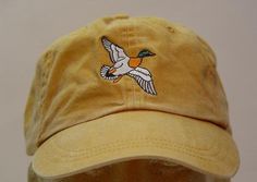 NEW EMBROIDERED MALLARD DUCK BIRD WILDLIFE BASEBALL HAT (HATS SHOWN ARE MUSTARD, OLIVE GREEN, NAVY BLUE, CARIBBEAN BLUE, KHAKI, MISSISSIPPI MUD AND WILD PLUM) Adams Optimum 6 Panel Baseball Hat Low Profile - 100% Cotton Twill Adult Cap Pigment Dyed - Garment Washed Hat 6 Panels with Sewn Matching Eyelet Visor with 3 Rows of Stitching Pre-formed Bill - Leather Strap with Brass Grommet Adjustable - One Size Fits Most An Extremely Comfortable Baseball Hat! Enjoy the Embroidered Mallard Duck Bird Ha Embroidery Apparel, Bird Hat, Hat Inspiration, Mississippi Mud, Duck Bird, How To Wash Hats, Mallard Duck, Hat Ideas, Embroidery On Clothes