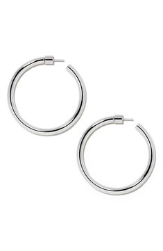 These minimalist hoop earrings were named after Fisher's grandmother and feature a lightweight design and 14-karat gold posts for daylong comfort. 1 1/2" hoop diameter; 1/8" width 14k gold post back Goldtone plate Imported Modern Polished Hoop Earrings For Everyday, Modern Rounded Everyday Earrings, Sleek Round Everyday Jewelry, Sleek Everyday Round Jewelry, Modern Everyday Circular Hoop Earrings, Contemporary Round Earrings For Everyday, Contemporary Round Earrings, Contemporary Everyday Round Earrings, Sleek Round Jewelry With Smooth Finish