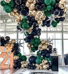 a large number of balloons are hanging from the ceiling