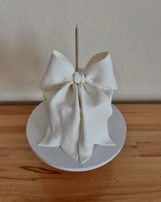 a white cake with a bow on top