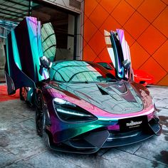 a colorful car parked in front of an orange building