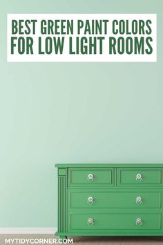 Room with green wall and chest and text overlay about the best green paint colors for low light rooms.