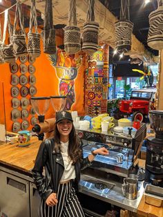 a woman standing in front of a coffee shop