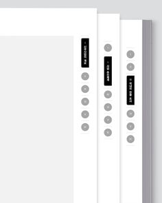 three white folders with black labels on them