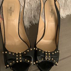 Gorgeous Valentino Garavni Leather Rockstud Bow Heels Pumps In Black. Give Your Look An Edgy Touch With Valentino’s Famous ‘Rockstud’ Pumps. Crafted From Calfskin Black Leather, These Platform-Heeled Peep-Toed Shoes Are Adorned With Studded Bows And A Comfortable Buckled Sling Back Strap. Excellent Condition. Never Worn. Size 40. Approx. Heel 5.25" Formal Studded Heels In Calf Leather, Formal Studded Calf Leather Heels, Formal Calf Leather Heels With Studs, Studded Calf Leather Evening Heels, Studded Calf Leather Heels For Evening, Chic Heels With Studded Rubber Outsoles, Designer Studded Open Toe Heels, Designer Open Toe Heels With Studs, Leather Heels With Gold Studs For Evening