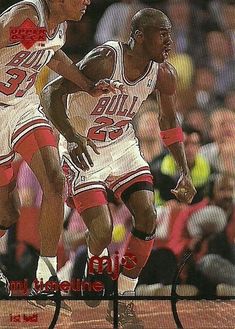 two basketball players in white uniforms on a court