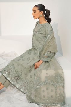 Pakistani Long Kameez Salwar and Dupatta Party Wear come in an Embellished Center Panel, Side Panels, Embroidered Sleeves, Embroidered Sleeves Border, Lace Neckline, Lace Patches for Slits, and Lace Borders. It is paired with Embroidered Net Dupatta, Embroidered Dupatta Length Border, and Embroidered Dupatta Pallu Border, it has Plain Dyed Back, paired with Plain Dyed Trousers. Detailed Description: SKU: PB0023 Detailing: Embroidery, Threads, Floral designs Color: Grey Fabric: Jacquard Design: F Long Kameez, Pakistani Boutique, Pakistani Designer Clothes, Border Lace, Eid Dresses, Jacquard Design, Embroidery Threads, Pakistan Fashion, Embroidered Sleeves