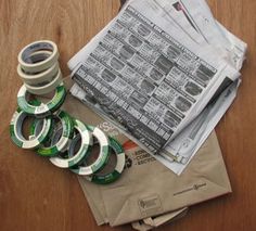 several rolls of tape sitting on top of newspapers