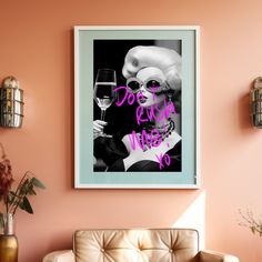 a living room with pink walls and framed art