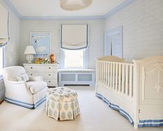 a baby's room with blue and white decor