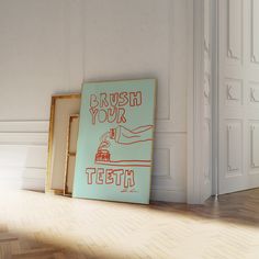 there is a painting on the floor in front of a door that says brush your teeth