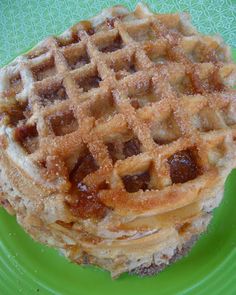 a stack of waffles sitting on top of a green plate