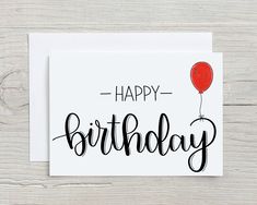 a birthday card with the words happy birthday written in black ink and a red balloon