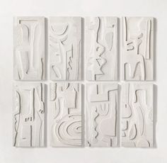 six pieces of white paper with different shapes and sizes on the wall, each depicting various objects