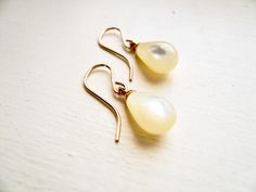 "Mother of Pearl Earrings. Dainty gold bridal jewelry. Tear Drop Pearl Earrings. June birthday birthstone gift. Vintage Limited Edition Timeless earrings for everyday, but special enough for a big day. Vintage mother of pearl (shell) teardrops with gold loops are suspended from high quality gold filled ear wires. Simple and classic. These drops are vintage, as such these earrings are a limited edition. These earrings measure just under 1\" (24mm) from the top of the ear wire's curve to the botto Gold Bridal Jewelry, Drop Pearl Earrings, Timeless Earrings, June Birthday, Mother Of Pearl Earrings, Coin Earrings, Earrings Dainty, Birthstone Gifts, Bridal Gold Jewellery