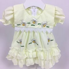 Yellow dress with embroidered poodles. Ruffle trim. Zipper on back. Tag says size: 2 but looks around 0-6 months. Check measurements below for fit.  Measurements (approximate): Shoulder to Hem: 14" Armpit to Armpit: 10" Brand: Minh Hanh Be sure to check out my shop! New items added often! https://www.etsy.com/shop/AutumnRoseArtVintage Embroidered Cotton Dress With Doll Collar, Cotton Embroidered Dress With Doll Collar, Cute Dresses With Embroidered Hem And Short Sleeves, Cute Short Sleeve Dress With Embroidered Hem, Fitted Cotton Dress With Machine Embroidery, Cotton Dresses With Ruffles And Doll Collar, Cotton Dresses With Machine Embroidery And Short Sleeves, Fitted Cotton Dresses With Picot Trim, Fitted Cotton Dress With Picot Trim