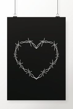 a heart made out of barbed wire on a black background