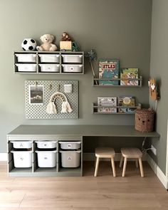 a child's playroom with toys and storage bins on the wall above