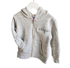 Fleece lined full zip-up hoodie. All styles include custom embroidery with your choice of phrase, font, thread color + text placement. Please make selections below. Material Content: 50% polyester, 37% ringspun cotton, 13% rayon Mockups provided upon request, please contact us. Click here for embroidery ideas *Style runs true to size, when in doubt size up :) ﻿Matches Little Kids Zip-Up Fleece Hoodie , Big Kids Zip-Up Fleece Hoodie, + Adult Zip-Up Fleece Hoodie Personalized Long Sleeve Cotton Hoodie, Personalized Cotton Sweatshirt For Winter, Casual Cotton Hoodie With Custom Text, Personalized Cotton Hoodie For Winter, Casual Personalized Cotton Hoodie, Casual Cotton Hoodie Personalized, Sporty Cotton Sweatshirt With Custom Text, Customizable Cotton Winter Hoodie, Customizable Cotton Hooded Hoodie