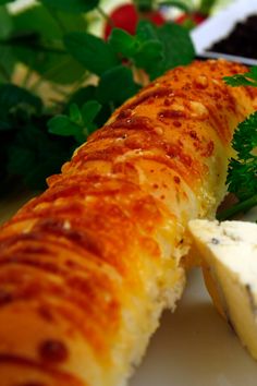 a piece of bread with cheese and parsley on it next to other food items