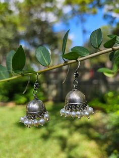 Gauri  - Our Handcrafted 925 Sterling Silver Jhumka Earrings Enhance your jewelry collection with our exquisite handcrafted silver jhumkas, a perfect blend of traditional charm and modern elegance. These minimal yet stunning earrings feature delicate pearls and intricate detailing, making them an ideal accessory for both contemporary and ethnic outfits. Handcrafted in Jaipur from pure sterling silver, these lightweight jhumkas are designed for comfort and style. Their small size adds a subtle touch of sophistication, perfect for any occasion. Whether you're dressing up for a festive celebration or adding a hint of Indian flair to your everyday look, these earrings are sure to impress. Key Features: * Pure sterling silver craftsmanship * Minimal design with traditional Indian aesthetics * L Affordable Traditional Jewelry With Tiny Beads, Traditional Cheap Jewelry With Round Beads, Cheap Silver Jewelry For Puja, Temple Earrings Ctr, Cheap Silver Jhumkas For Party, Indian Earrings Traditional Studs, Simple Silver Indian Jewelry, Traditional Cheap Sterling Silver Earrings, Cheap Women's Drop Jhumkas