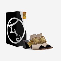 This slide sandal is characterized by a finely cutout upper crossed by a wide strap. An oversized gold-tone buckle is placed on the front of the vamp and adds a sumptuous element of refinement. The PVC block-heel and the lightly padded insole provide easy stepping. Luxury Mules With Wrapped Heel For Formal Occasions, Elegant Sandals With Gold Buckle For Summer, Luxury Formal Mules With Wrapped Heel, Elegant Summer Sandals With Gold Buckle, Luxury Gold Sandals With Buckle Closure, Elegant Open Toe Sandals With Gold Buckle, Elegant Leather Slides With Sculpted Heel, Luxury Heels With Tang Buckle, Luxury Summer Heels With Gold-tone Hardware