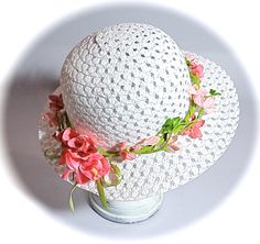 "This little girls Easter bonnet or tea party hat is a white open weave sun hat with a wired leaf green garland that wraps the crown.  The garland is sprinkled with velvet flowers in shades of pink.  The hat is perfect for Easter or a flower girl in a garden wedding!  This hat measures 20-1/2\" at the crown...be sure to measure mid forehead before ordering!  To view my entire collection of Girl's Hats click on this Section.... https://www.etsy.com/your/shops/Marcellefinery/sections/16935555 Prev Adjustable Flower Sun Hat For Spring, Whimsical Spring Sun Hat, Brimmed Sun Hat For Spring, Whimsical White Adjustable Hat, Summer Mini Hats, Adjustable For Garden Party, White Flower Mini Hat For Garden Party, Handmade White Brimmed Mini Hats, Pink Flower Mini Hat Adjustable, Spring Beach Crochet Hat With Flower Shape