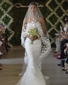 a woman in a white wedding dress and veil