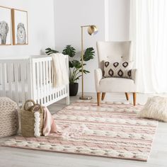 a baby's room with a white crib, pink rug and two chairs