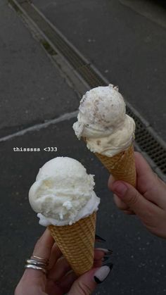 two ice cream cones sitting on top of each other