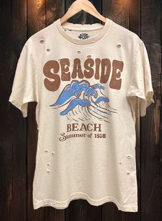 Country Deep Seaside Beach Summer of 1988 Vintage unisex distressed T shirt in vintage natural color Vintage country western cowboy T shirt 40 Singles Jersey 100% Cotton Premium quality ringspun and compacted cotton Fine Cotton Jersey that is pigment dyed for a more vintage look Features tears and destroyed features at neck and on body Each piece is unique as this process is done by hand! 3.8 oz Made In USA Every garment dye item can be a slightly different shade in color and distressed since th Vintage Washed T-shirt For Spring, Faded Retro T-shirt For Summer, Faded Distressed T-shirt For Summer, Vintage Relaxed Fit Distressed Top, Vintage Distressed Tops With Relaxed Fit, Vintage Distressed Top With Relaxed Fit, Relaxed Fit Bleached T-shirt For Summer, Summer Bleached Relaxed Fit T-shirt, Vintage Distressed T-shirt With Relaxed Fit