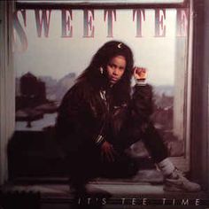 a woman sitting on top of a window sill next to a sign that says sweet t