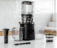 a blender sitting on top of a counter next to other kitchen items and utensils