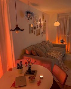 a living room filled with furniture next to a window covered in curtains and light bulbs